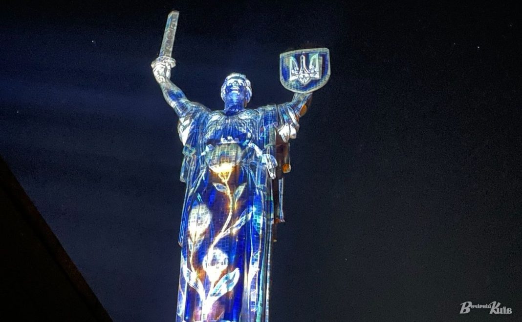 Монумент «Батьківщина-мати» з підсвіченою проєкцією вночі